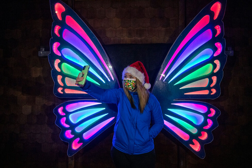 woman takes selfie with butterfly wings