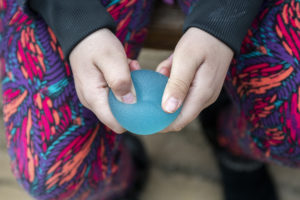 blue fidget toy in hands