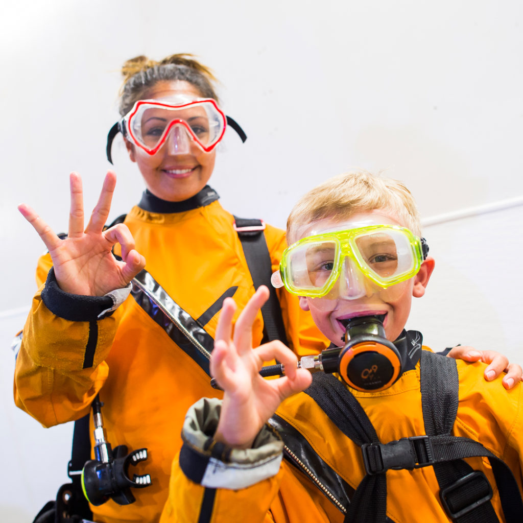 mom and son get ready for shark dive